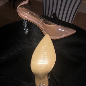 Clear pumps with tan inner lining. Clear circular heel